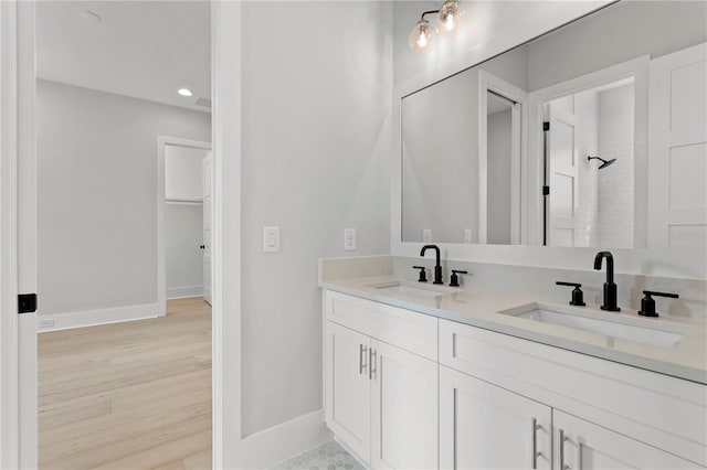 bathroom featuring vanity, hardwood / wood-style floors, and a shower