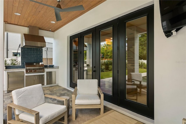 exterior space with a healthy amount of sunlight, wooden ceiling, and ceiling fan