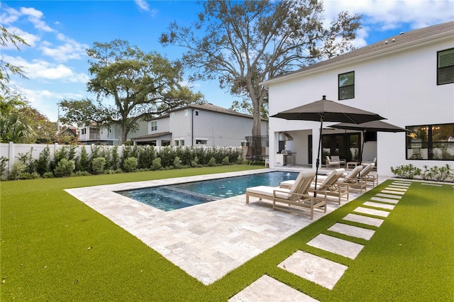 view of swimming pool with a yard and a patio area