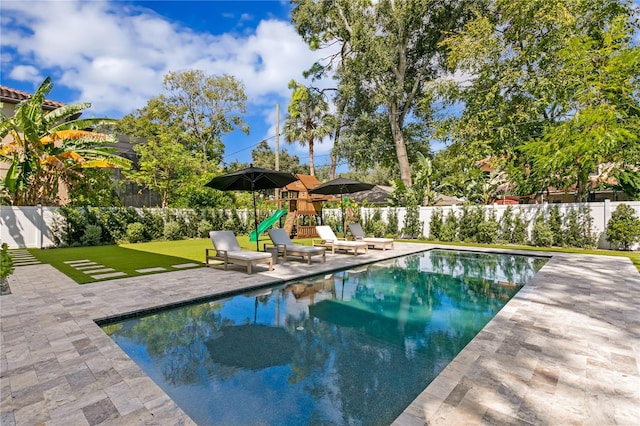 view of swimming pool with a patio and a yard