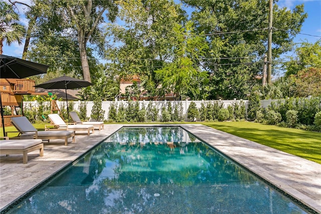 view of pool with a yard, a patio area, and a playground