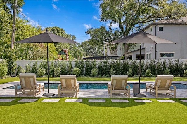 view of pool with a lawn