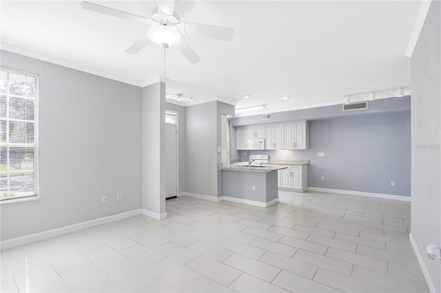 unfurnished living room with ornamental molding, light tile patterned flooring, sink, and ceiling fan