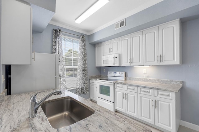 kitchen featuring white cabinets, sink, and white appliances