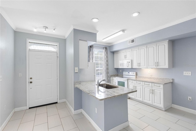 kitchen with white appliances, crown molding, sink, and white cabinets