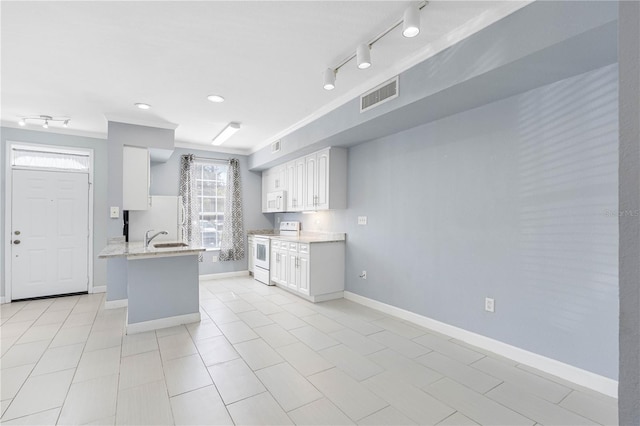 kitchen with white appliances, light tile patterned flooring, sink, kitchen peninsula, and white cabinetry