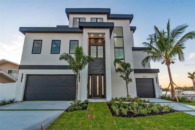 2832 W Vina Del Mar Blvd, St Pete Beach, FL 33706 - modern home with stucco siding, concrete driveway, and an attached garage