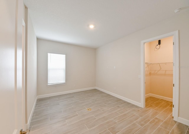 unfurnished bedroom featuring a closet and a spacious closet