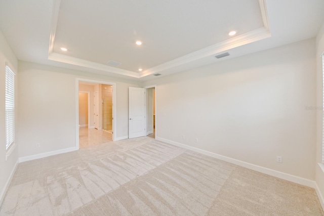 interior space featuring a healthy amount of sunlight, ornamental molding, and a tray ceiling