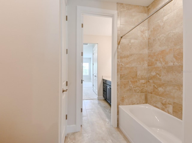 bathroom with vanity, tile patterned floors, and tiled shower / bath combo