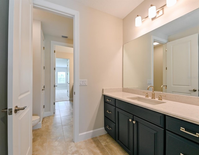 bathroom featuring vanity, toilet, and tile patterned floors