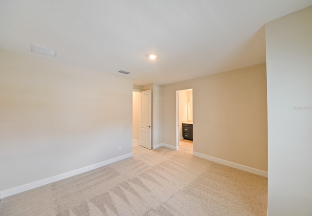 unfurnished room featuring light colored carpet