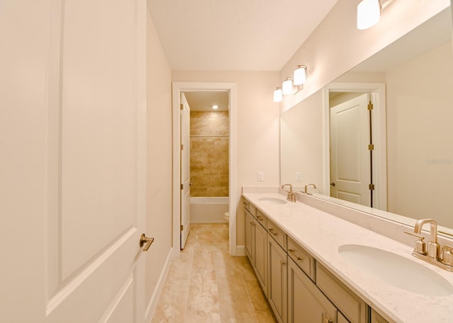 full bathroom with vanity, toilet, and tiled shower / bath