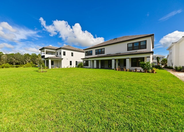 rear view of property with a yard