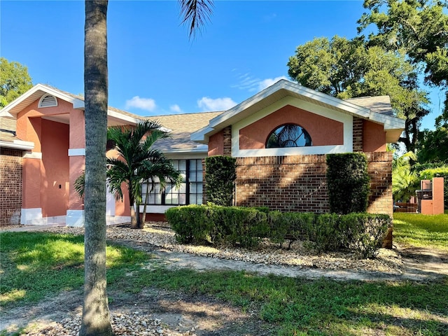 ranch-style home with a front lawn