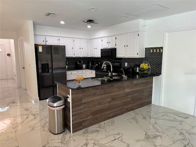 kitchen featuring tasteful backsplash, black appliances, sink, and kitchen peninsula