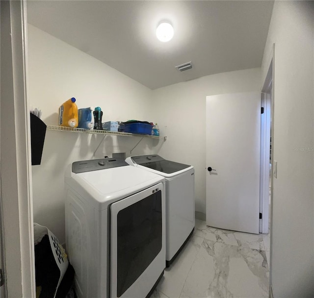 clothes washing area with independent washer and dryer