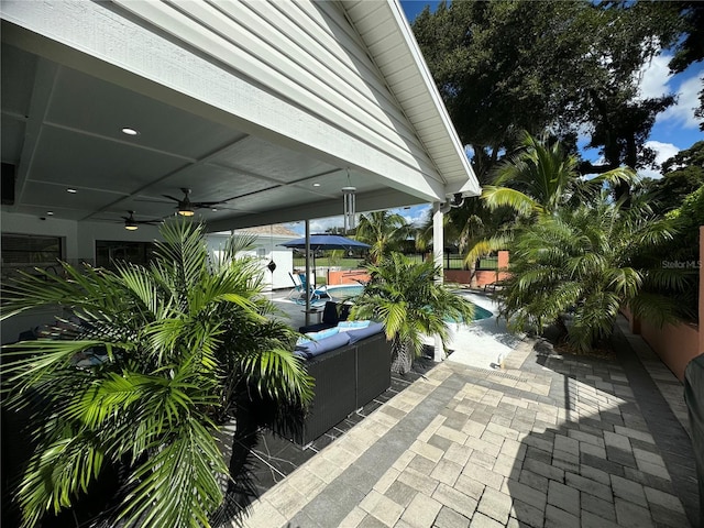 view of patio with outdoor lounge area, a swimming pool, and ceiling fan