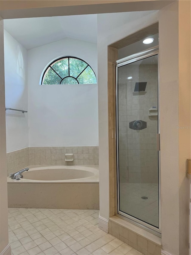 bathroom featuring tile patterned flooring, plus walk in shower, and vaulted ceiling