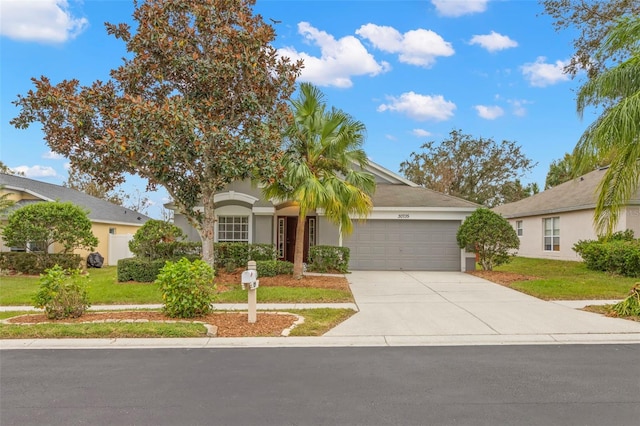 obstructed view of property with a front lawn and a garage