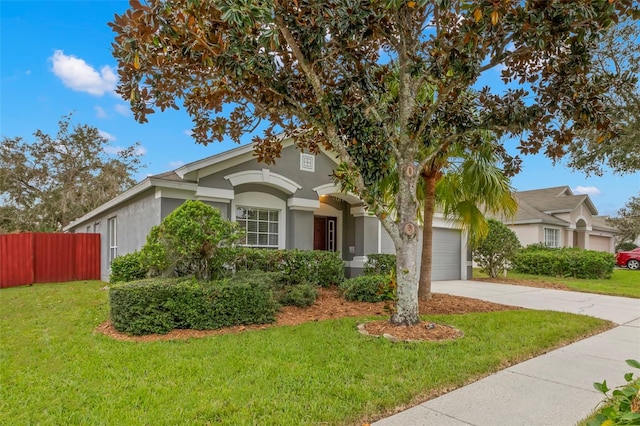 view of front of home featuring a front yard and a garage