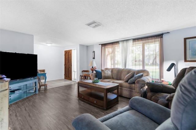 living room featuring hardwood / wood-style floors and a textured ceiling