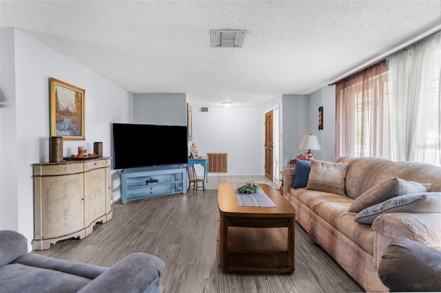 living room with hardwood / wood-style floors and a textured ceiling