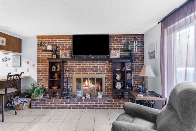 tiled living room featuring a brick fireplace and a textured ceiling