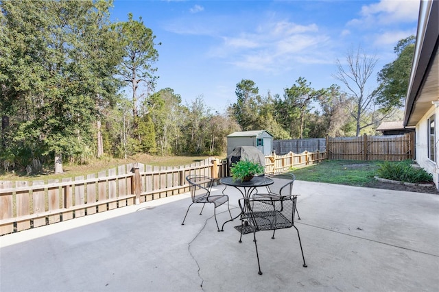 view of patio featuring a storage unit