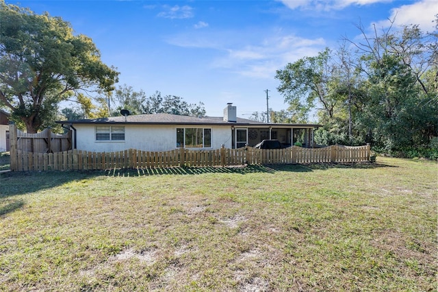 back of property featuring a lawn