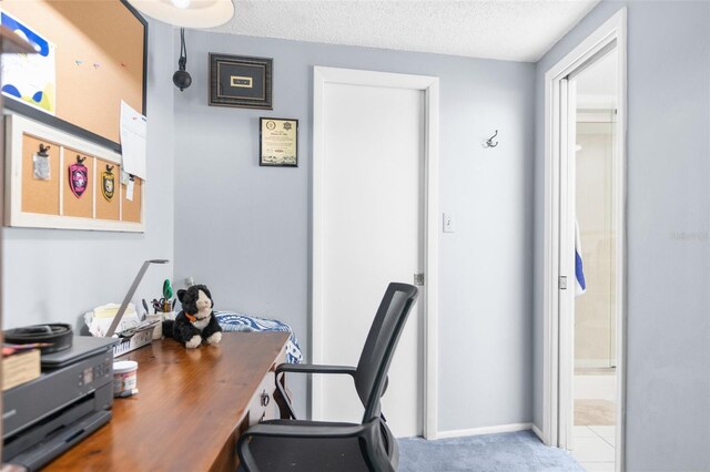 carpeted office with a textured ceiling