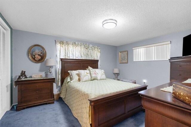 carpeted bedroom featuring a closet and a textured ceiling