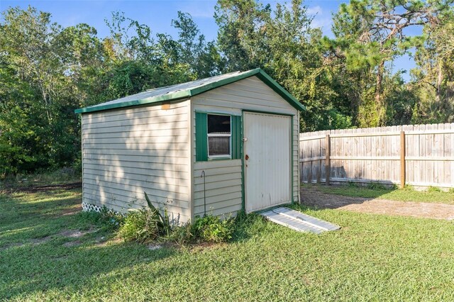 view of outdoor structure with a lawn