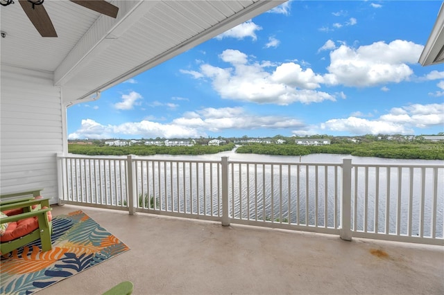 view of patio with a water view and a balcony