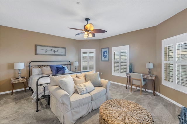 bedroom featuring light colored carpet and ceiling fan