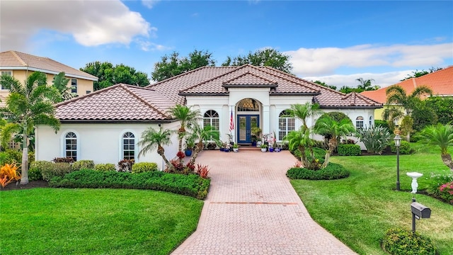 mediterranean / spanish house with a front lawn