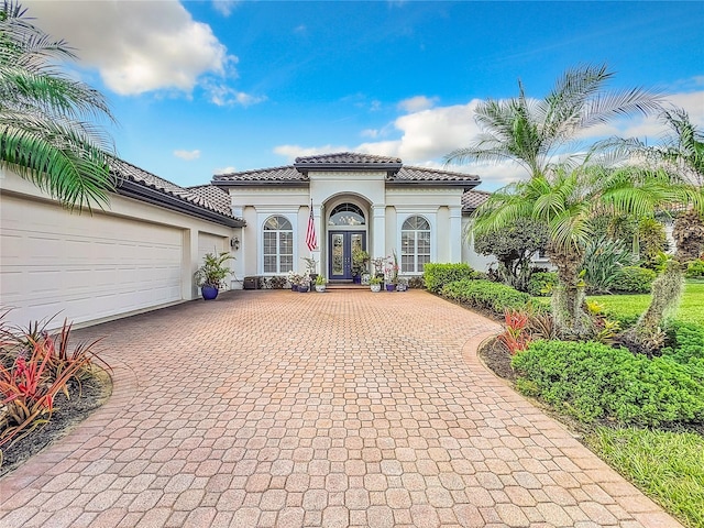 mediterranean / spanish house featuring a garage