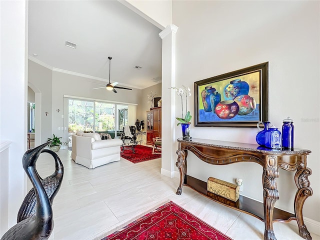 living room with ceiling fan and crown molding