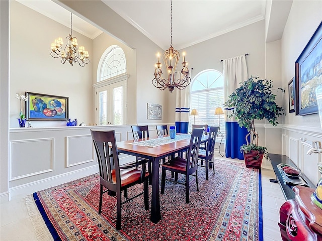 dining area featuring a wealth of natural light, ornamental molding, and an inviting chandelier