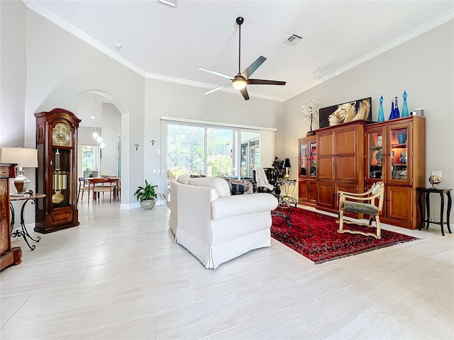 tiled living room featuring crown molding and ceiling fan