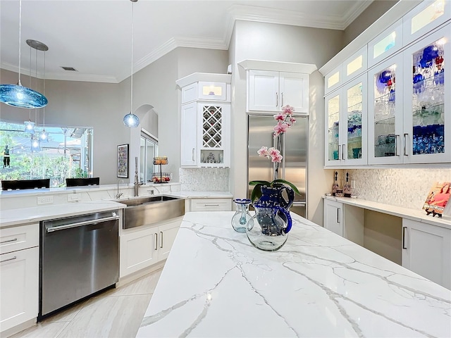 kitchen featuring sink, stainless steel appliances, decorative light fixtures, white cabinets, and decorative backsplash