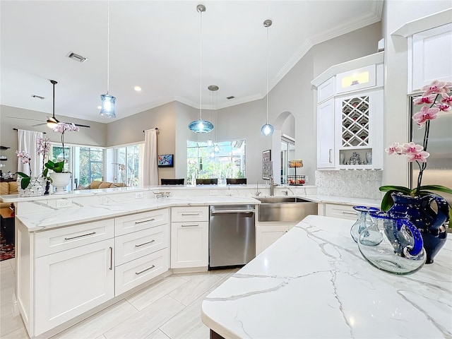 kitchen with stainless steel dishwasher, white cabinetry, light stone counters, and pendant lighting