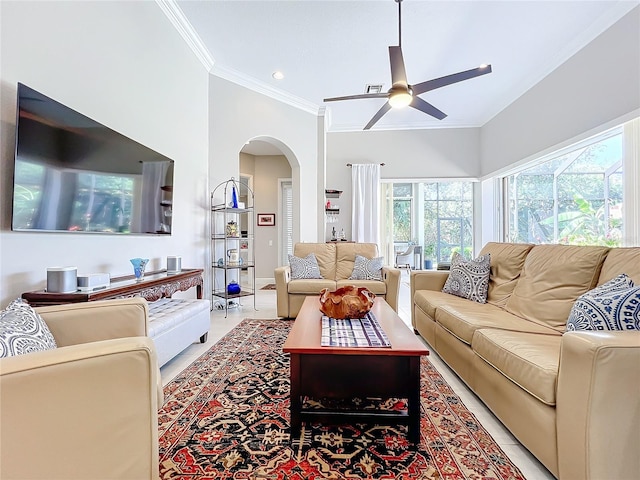 living room with crown molding, light tile patterned floors, and ceiling fan