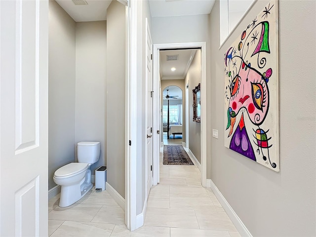 bathroom with toilet, tile patterned floors, and ornamental molding