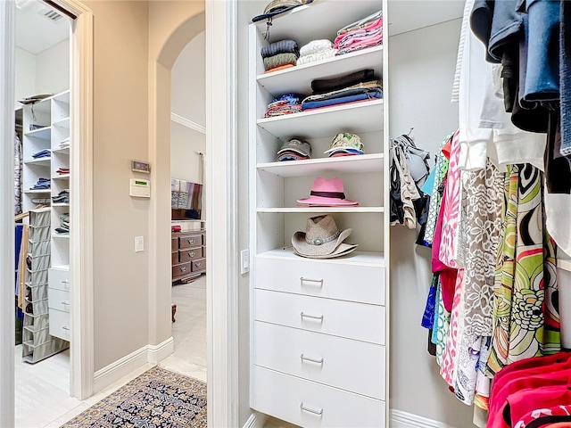 walk in closet with light tile patterned flooring