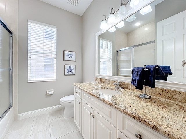 full bathroom featuring toilet, bath / shower combo with glass door, vanity, and tile patterned floors