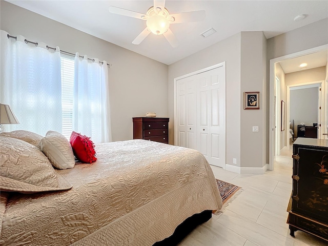 tiled bedroom with a closet and ceiling fan