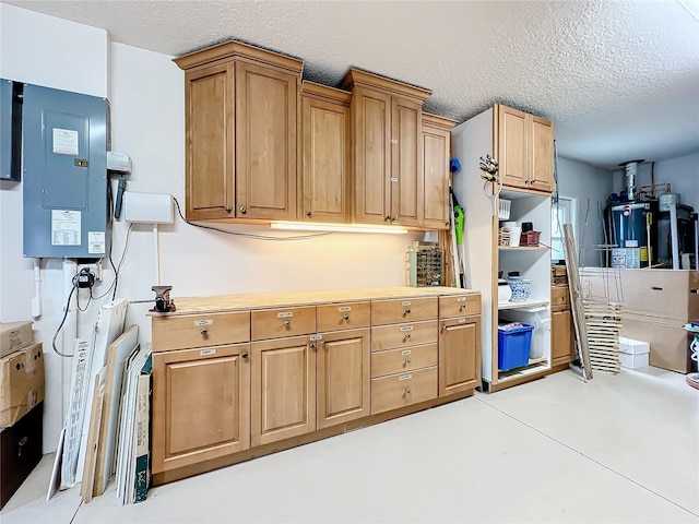 kitchen featuring water heater, electric panel, and a textured ceiling