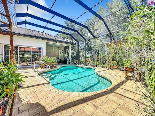 view of swimming pool with a patio area and a lanai