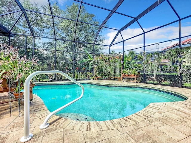 view of swimming pool featuring a patio and a lanai